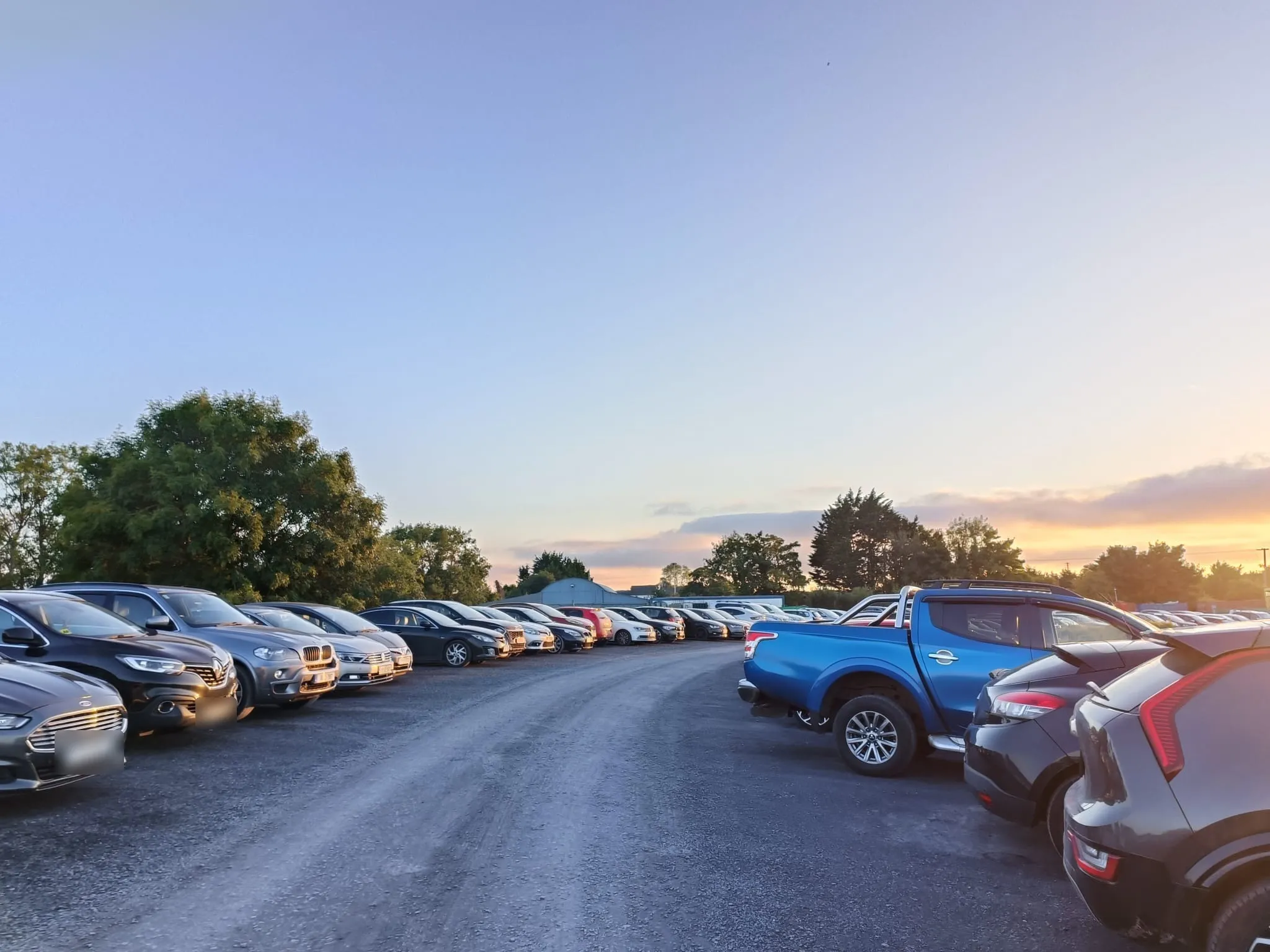 Park and Fly Dublin car park at sunset with rows of parked cars
